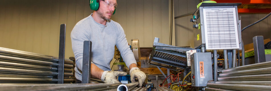 man working with metal pipes