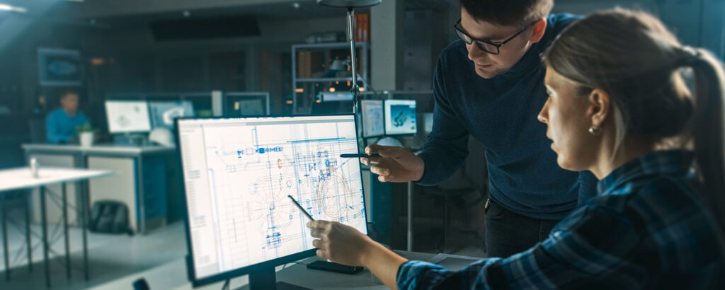 people looking at blue print on computer screen