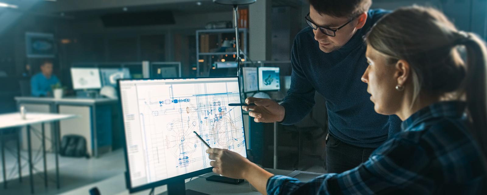 people looking at blue print on computer screen