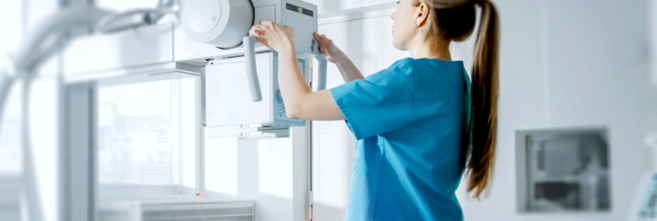 nurse using machine to take scan of patient