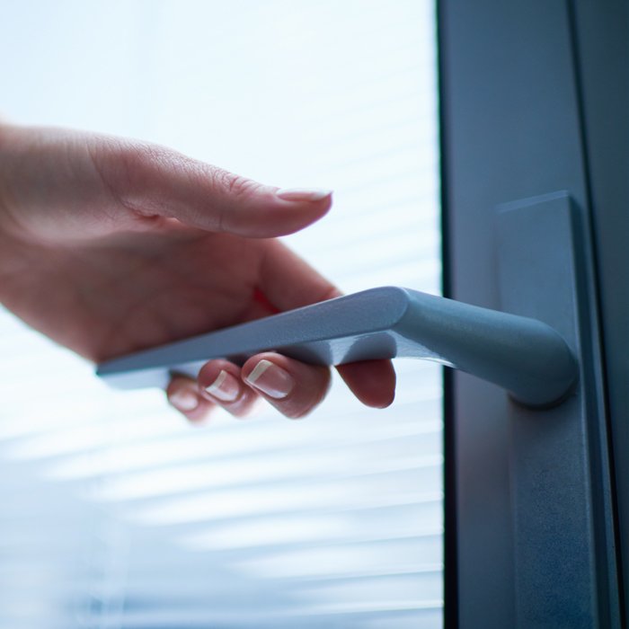 woman's hand turning a door handle
