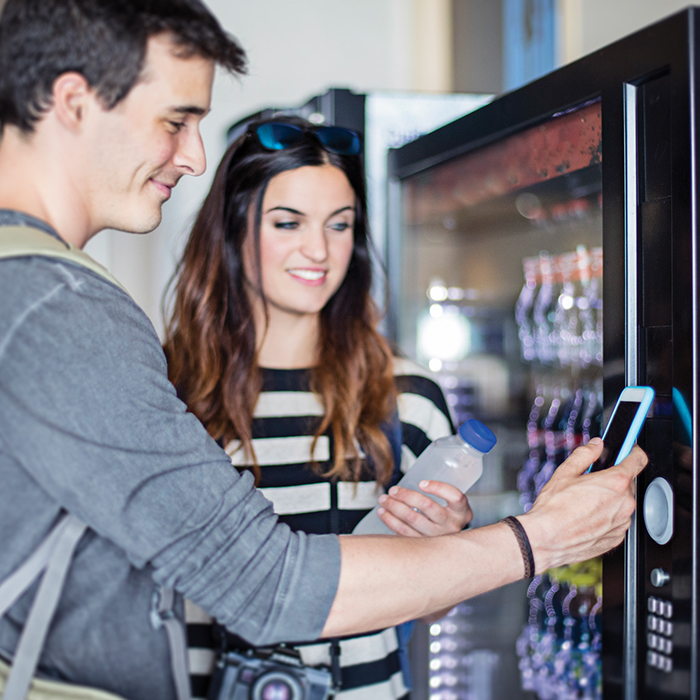 two people paying a vending machine